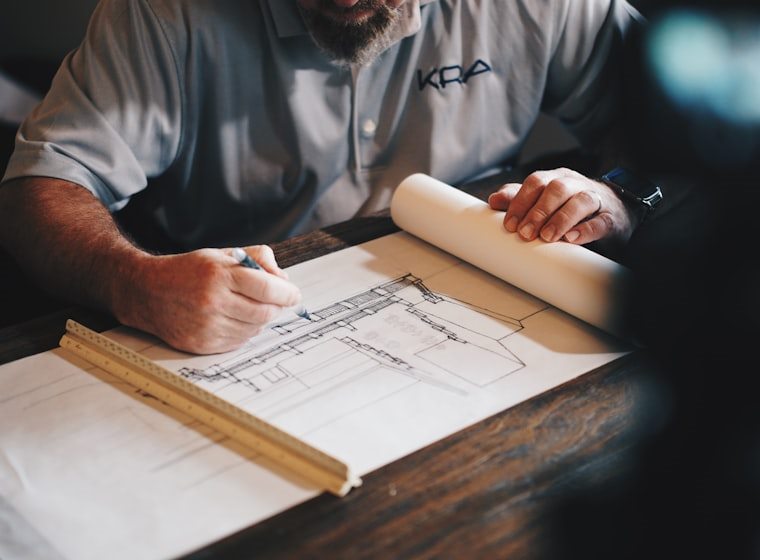 Ironclad project manager reviewing plans on site